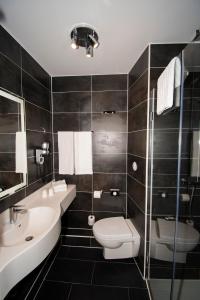 a bathroom with a toilet and a sink at K Hotel in Strasbourg