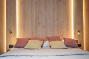 a bed with four pillows on top of it at Villa dei Larici in Camigliatello Silano