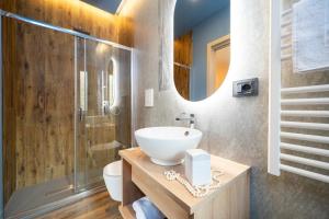 a bathroom with a sink and a toilet and a mirror at Villa dei Larici in Camigliatello Silano