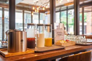 a bar with two pitchers of drinks on a table at Parkavenue Guesthouse in Seoul