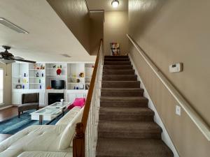 a staircase in a living room with a bed and a stair case at A stylish and Comfy Place to Stay in Gainesville