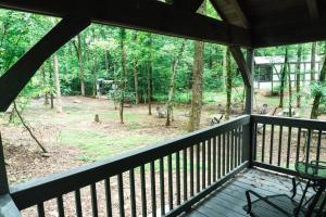 una veranda schermata con vista su una foresta di Tiny Home Cottage Near the Smokies #10 Helena a Sevierville