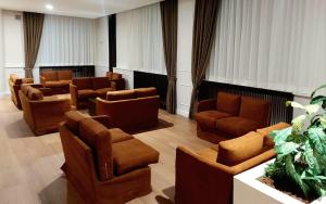 a waiting room with couches and chairs at Hotel Meranda in Camigliatello Silano