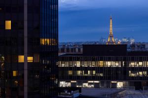 a view of the eiffel tower from between two buildings at Les Artistes in Paris