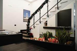 a staircase with christmas decorations in a room at Domea Superior Rooms Bed and Breakfast in Reggio di Calabria