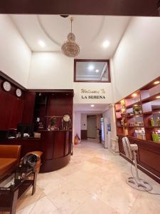 a lobby of a restaurant with a sign on the wall at La Serena Boutique Hotel in Ho Chi Minh City