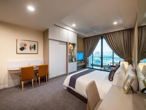 a hotel room with a large bed and a desk at Sunway Sanctuary - Seniors Hotel & Residences in Subang Jaya