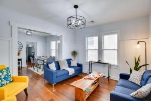 a living room with blue couches and a table at Atlantic City Home about 2 Mi to Ocean Casino Resort! in Atlantic City