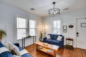 a living room with a blue couch and a table at Atlantic City Home about 2 Mi to Ocean Casino Resort! in Atlantic City