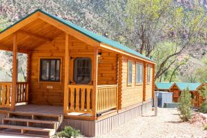 a log cabin with a porch and a deck at Zion Canyon Cabins in Springdale