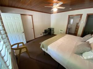 a bedroom with a bed and a ceiling fan at Seven Circles Lodge&Retreat in Badger