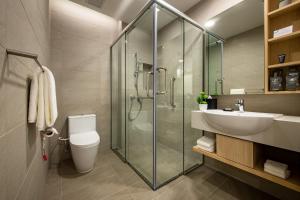 a bathroom with a shower and a sink and a toilet at Sunway Sanctuary - Seniors Hotel & Residences in Subang Jaya