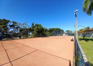 a tennis court with a net on top of it at Acquamarine Park Hotel in Guarapari