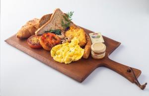 a plate of breakfast food with eggs bread and toast at Sunway Sanctuary - Seniors Hotel & Residences in Subang Jaya