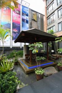 a table with an umbrella in front of a building at Einhan Resort in Yuchi