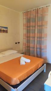 a bedroom with a bed with two towels on it at T'Addormento in Reggio di Calabria