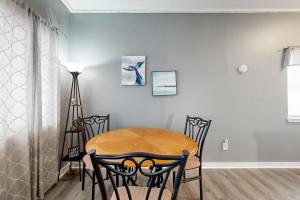 a dining room with a wooden table and chairs at Okaloosa Island Studio in Fort Walton Beach