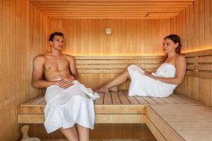 een man en een vrouw in een sauna bij HOODY ACTIVE & HAPPINESS HOTEL in Arco