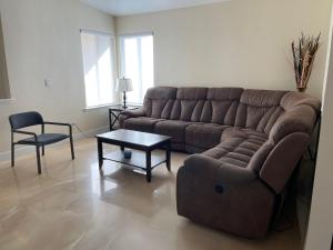 a living room with a couch and a table at Newly Remodeled Family Friendly 3B/2B House in Henderson