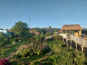 a view of a garden with trees and a building at K'Ho Cil Homestay Tà Nung in Da Lat