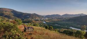 a view of a valley with a river and mountains at K'Ho Cil Homestay Tà Nung in Da Lat