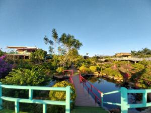 a bridge over a pond in a garden at K'Ho Cil Homestay Tà Nung in Da Lat