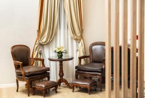 two chairs and a table in front of a window at Melia Recoleta Plaza Hotel in Buenos Aires