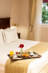 a tray with food on top of a bed at Melia Recoleta Plaza Hotel in Buenos Aires