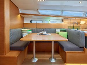 a table and bench in a kitchen on a yacht at Sleep aboard a modern sailboat in Oeiras in Oeiras