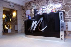 a display in a room with a wall with the m logo at Hotel Montenegro Compostela in Santiago de Compostela