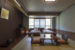 A bed or beds in a room at Takamiya Bettei Kuon