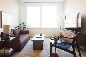 a living room with a couch and a tv at ROOST Kelly Drive in Philadelphia