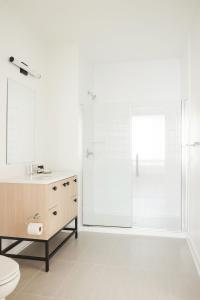 a bathroom with a shower and a toilet and a sink at ROOST Kelly Drive in Philadelphia