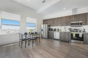 a kitchen with a table and chairs and a refrigerator at Contemporary 2BR I Gym I Parking I Workspace in Dallas