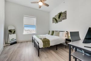 a white bedroom with a bed and a desk at Contemporary 2BR I Gym I Parking I Workspace in Dallas