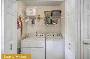 a laundry room with a washer and dryer at Estrella del Mar in Panama City Beach