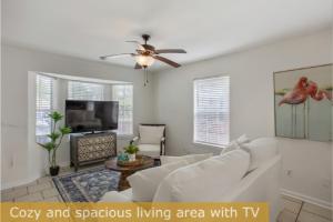 a living room with a white couch and a ceiling fan at Estrella del Mar in Panama City Beach