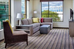 a living room with a couch and a chair at Hyatt House Seattle Downtown in Seattle