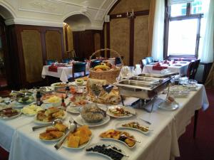 a long table filled with different types of food at Hotel Leopold I in Novi Sad