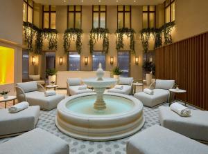 a lobby with a fountain in the middle of a room at The Hotel Maria - Preferred Hotels & Resorts in Helsinki