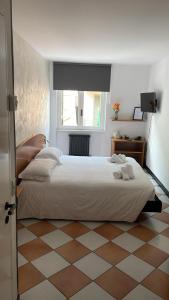 a bedroom with a large white bed and a window at Hotel Montecodeno in Varenna