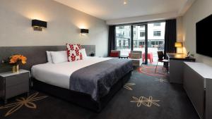 a hotel room with a bed and a desk at SkyCity Hotel Auckland in Auckland