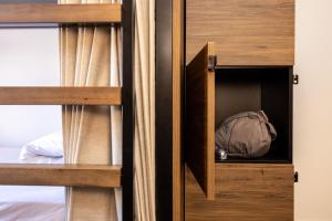 a closet with two bunk beds and a backpack at Haka House Lake Tekapo in Lake Tekapo