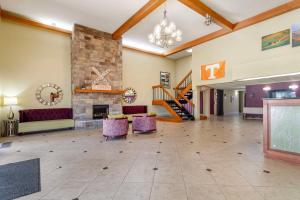 a lobby with a fireplace and couches and stairs at Best Western Plus Knoxville Cedar Bluff in Knoxville