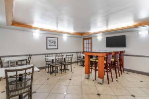 a room with tables and chairs and a flat screen tv at Best Western Plus Knoxville Cedar Bluff in Knoxville