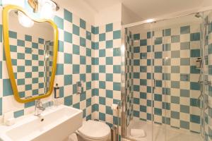 a bathroom with a sink and a toilet and a mirror at Westlight Lisboa Madalena in Lisbon