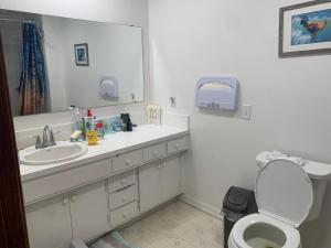 a bathroom with a sink and a toilet and a mirror at GardenView queen-size bedroom in Redmond