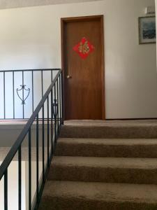 a wooden door with a red shield on it at GardenView queen-size bedroom in Redmond