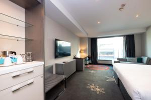 a hotel room with a bed and a television at SkyCity Hotel Auckland in Auckland