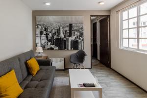 a living room with a couch and a window at OM 686 URBAN LOFTS Narvarte in Mexico City